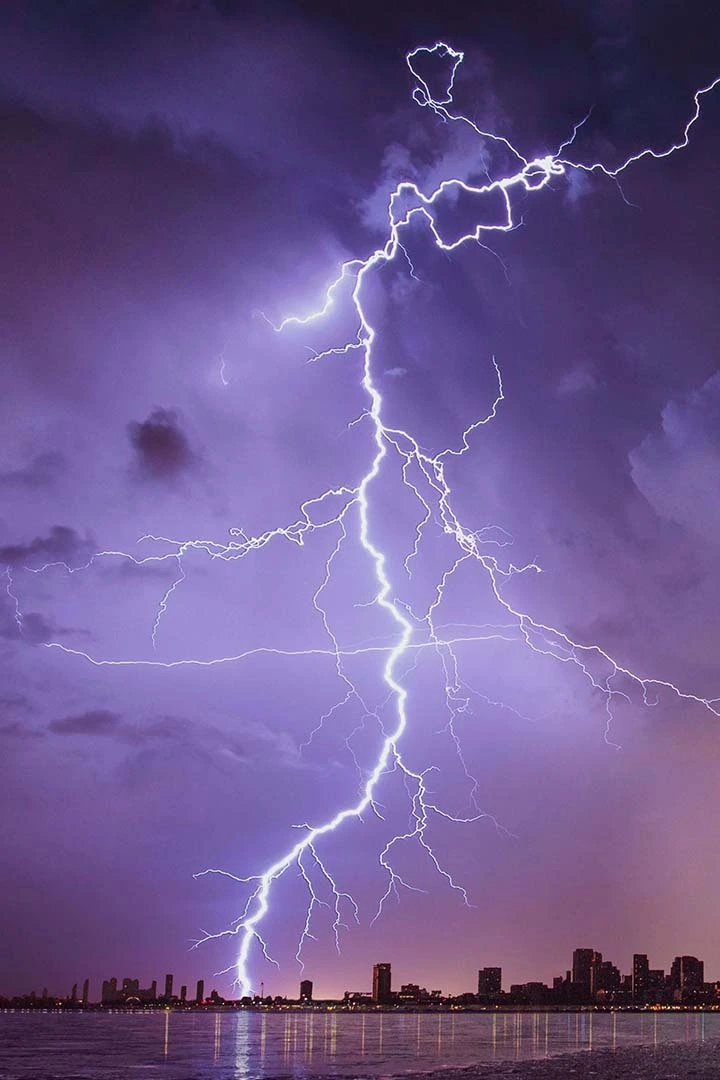 Lightning striking the city skyline during a storm
